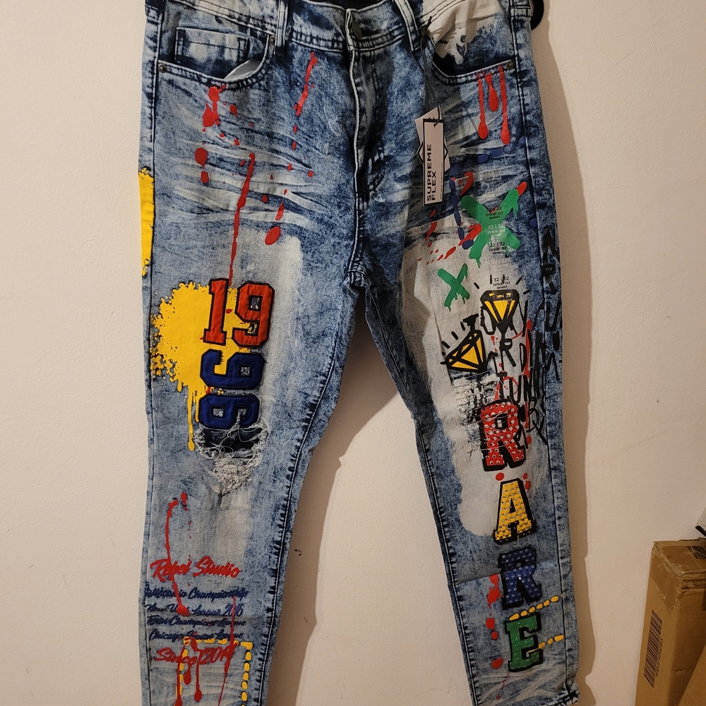 Supreme Men's Distressed Blue Jeans with Colorful Graphics